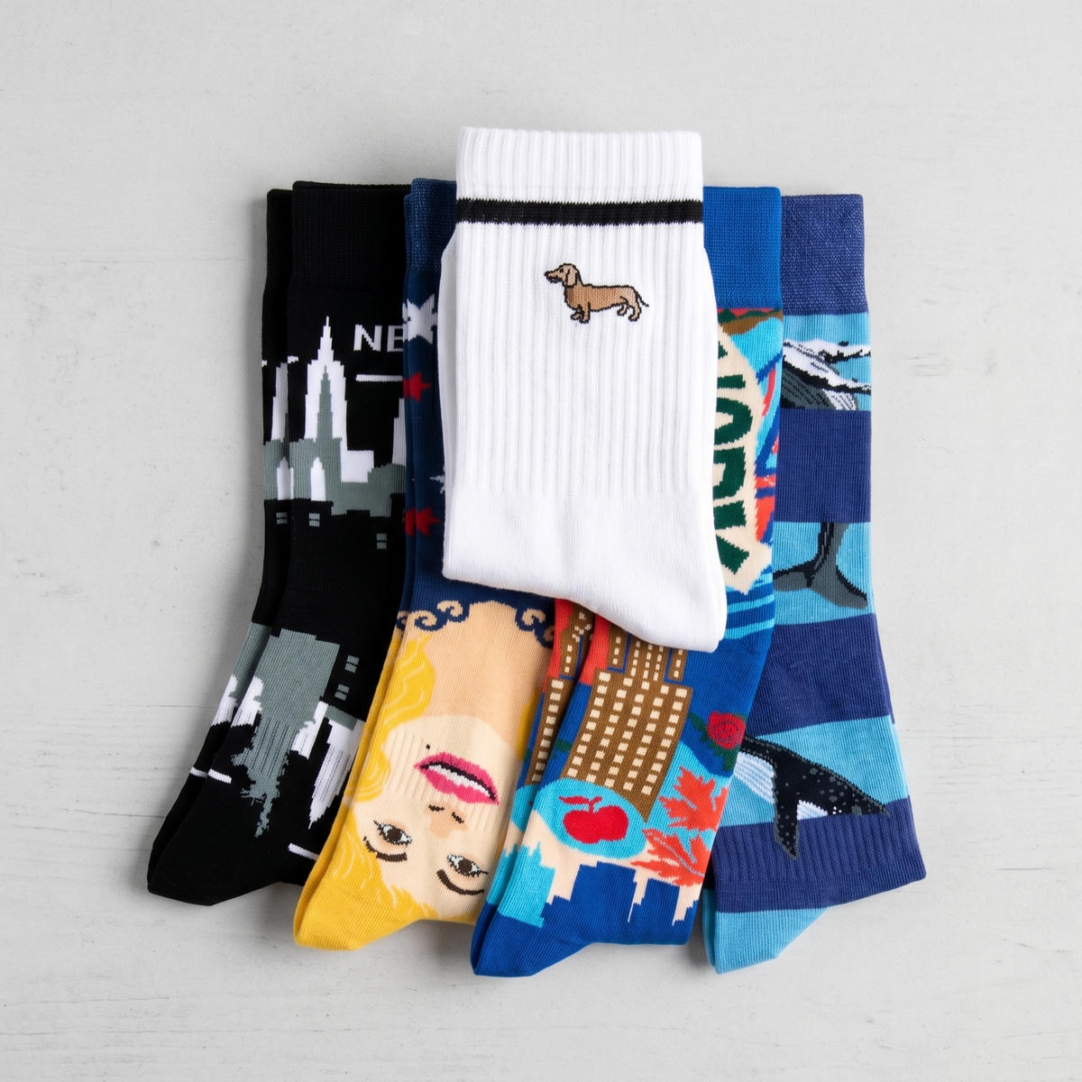 Set of colorful socks with various designs on a light gray background
